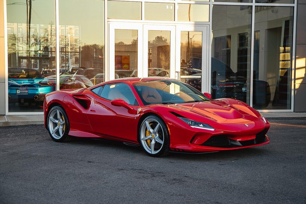 Red Ferrari F8 Tributo parked at the exotic car rental lot in Miami